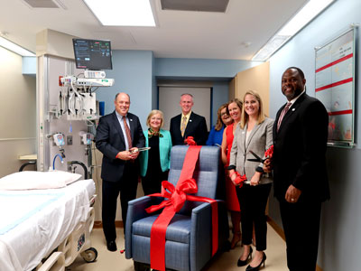 SECU leadership at a ribbon-cutting ceremony to celebrate the 19 sleep chairs they donated to the PICU unit at University of Maryland Children's Hospital. These chairs allow parents to stay by their child's side and gives them a comfortable place to rest as their child is being cared for.